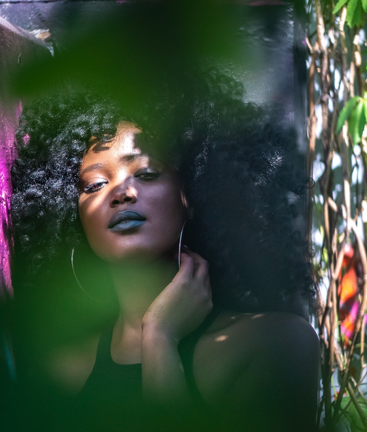 Moody portrait among greenery