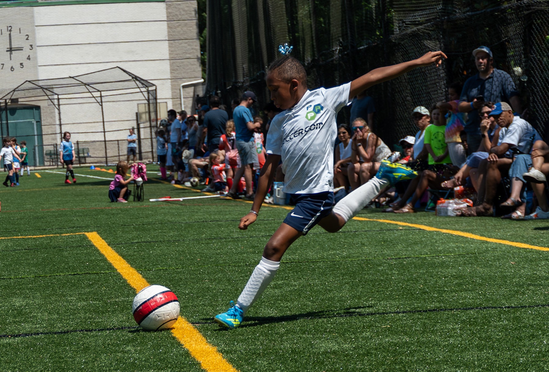 Youth soccer player kicking the ball