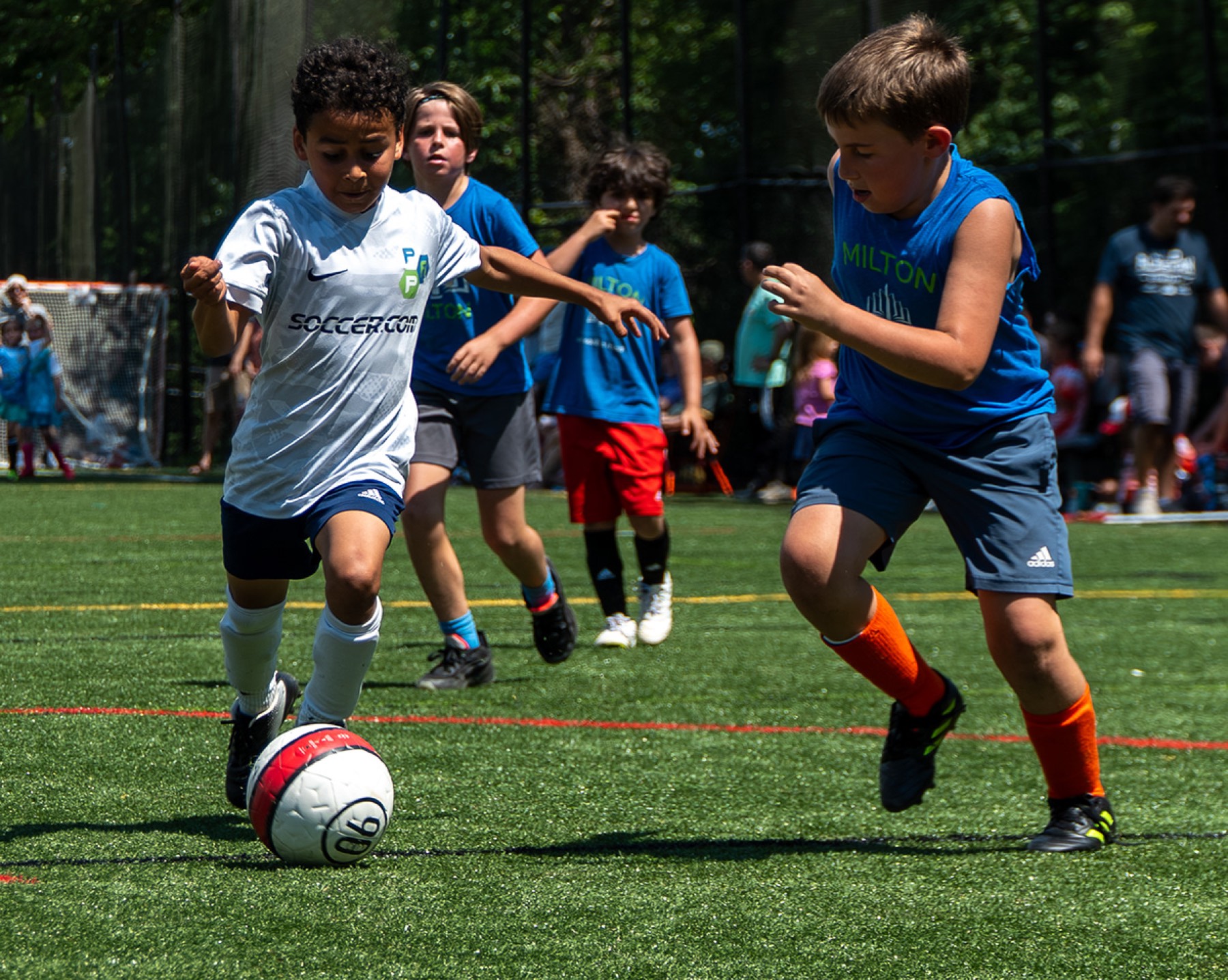 Youth soccer players challenging for the ball