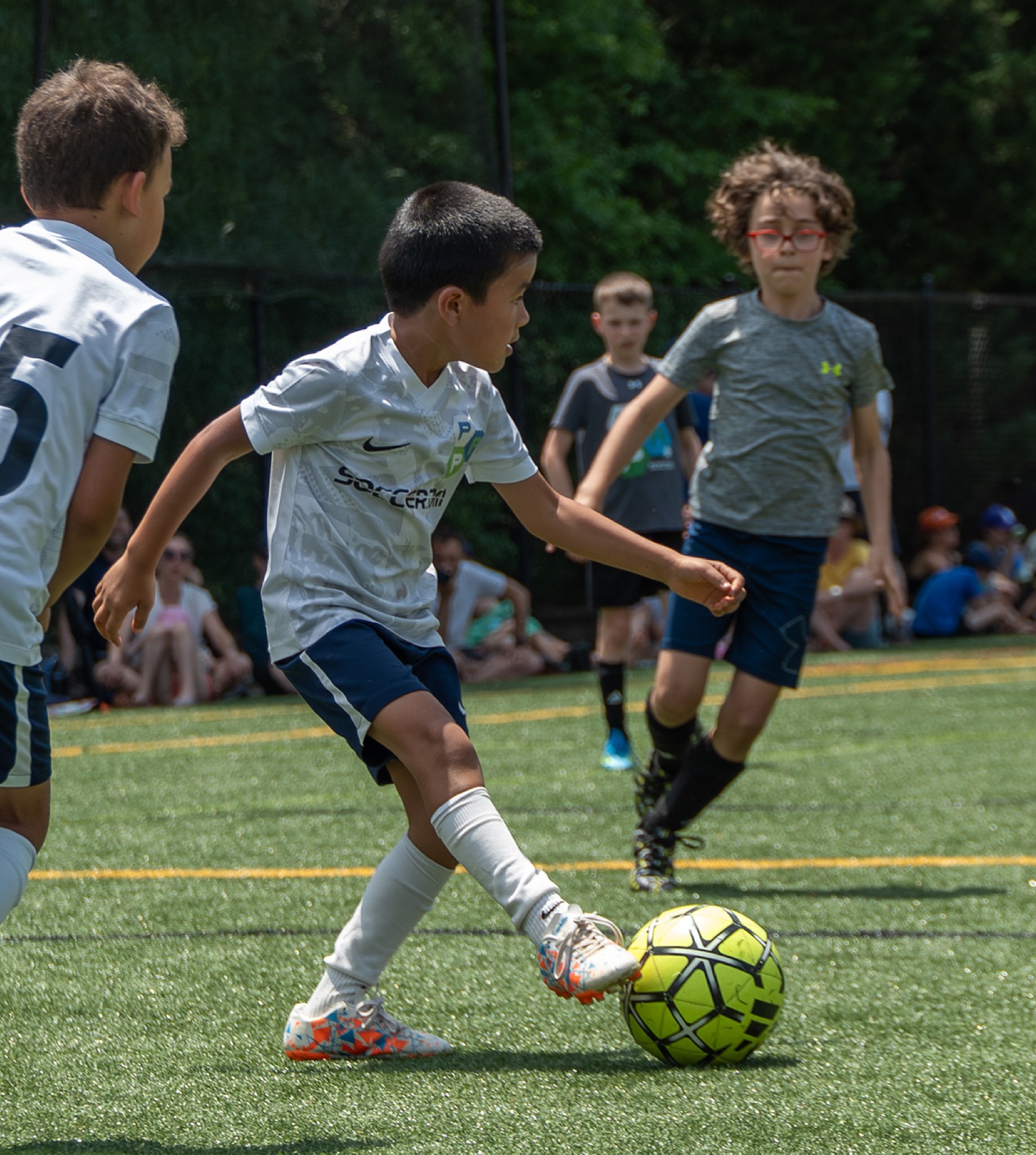 Youth soccer player dribbling downfield